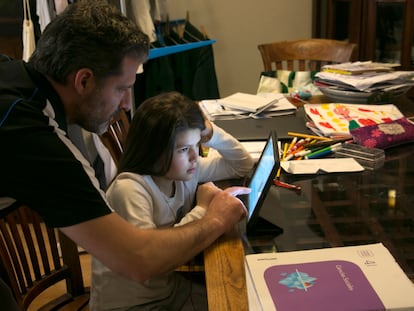 Spanish children taking online classes at home on March 11.