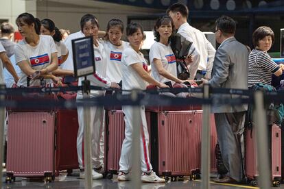 North Korean women line up for a flight to Astana at the Capital Airport in Beijing