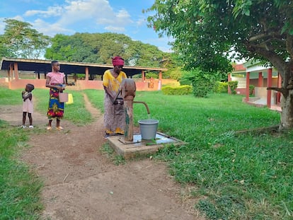 Una mujer, acompañante de un paciente, extrae agua para el consumo de un pozo en el hospital Saint Michel de Zoukougbeu.