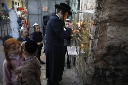 An Orthodox Jew lights a candle on the second night of Hanukkah in Jerusalem.