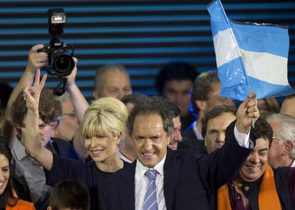 El kirchnerista moderado Daniel Scioli festeja el resultado electoral este domingo en el estadio Luna Park con su esposa, Karina Rabolini.