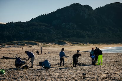 Un grupo de voluntarios, durante la quedada para la limpieza de los 'pellets' en la playa de Area Maior en Muros (A Coruña), el 7 de enero.