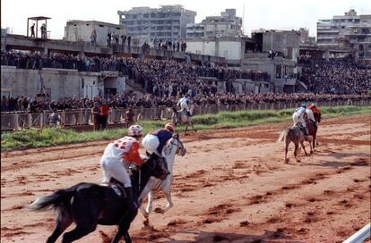 Jockeys compete during a horse race at Beirut Hippodrome, Lebanon, in 1992. REUTERS/Jamal Saidi  SEARCH "SAIDI HIPPODROME" FOR THIS STORY. SEARCH "WIDER IMAGE" FOR ALL STORIES.