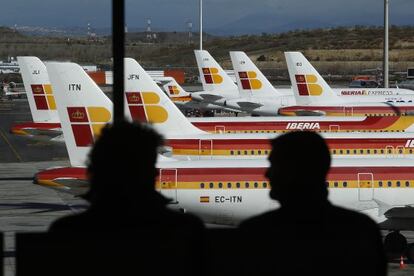 Pasajeros frente a aviones de Iberia en Madrid- Barajas