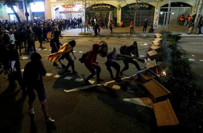 Protesters form a barricade using planters during a protest in Barcelona against the Supreme Court ruling, which sentenced nine separatist leaders to prison for sedition.