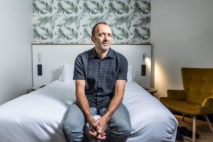 El escritor Isaac Rosa, en la cama de su habitación en un hotel céntrico de Madrid, el 4 de septiembre de 2025.