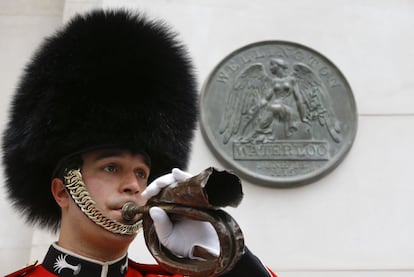 Bugler Lance Corporal Nick Walkley of the Band of the Welsh Guards plays a bugle found on the body of a bugler at the Battle of Waterloo, after the new memorial was unveiled at Waterloo Station in London, Wednesday, June 10, 2015. The new war memorial honours all of the allied forces who fought at the Battle of Waterloo in 1815. The centrepiece is a giant replica of the reverse of the Waterloo Campaign medal. (AP Photo/Kirsty Wigglesworth)