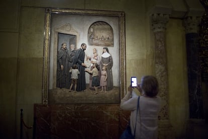 Una mujer fotografía un cuadro religioso en el interior de la mezquita.