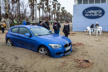 Un vehículo atrapado en la arena que invadió el paseo marítimo de Valencia,en la playa de la Malvarrosa, el pasado miércoles.
