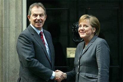 Angela Merkel saluda a Tony Blair en la puerta de su residencia oficial en Londres.