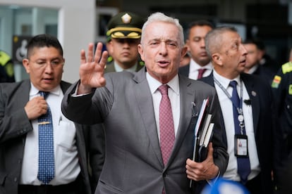 Former President Alvaro Uribe leaves court after a hearing of his trial on charges of witness tampering and bribery in Bogota, Colombia, Monday, Feb. 10, 2025. (AP Photo/Fernando Vergara)