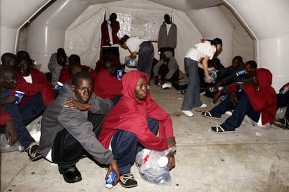 La Cruz Roja atiende a varios de los inmigrantes que ayer llegaron al puerto de Los Cristianos, en Tenerife.