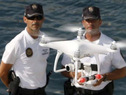 Agentes da polícia local de Benidorm e o drone usado para monitorar o litoral.