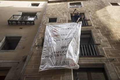 Activists unfurl a banner protesting against illegally let apartments.