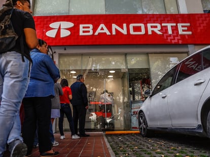 Clientes hacen fila para usar cajeros automáticos en una sucursal bancaria de Grupo Financiero Banorte, en Ciudad de México.