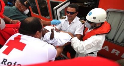 Red Cross volunteers move a baby who reached Tarifa by boat on Monday.