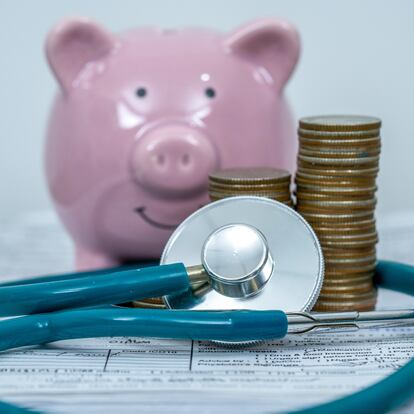 Pink piggy bank with stethoscope and coin money.Medical insurance concept.