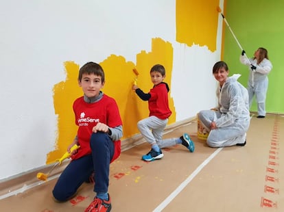 Voluntarios de HomeServe y sus familiares pintan un local de la Fundación Down.