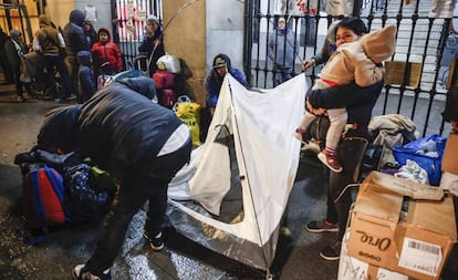 Asylum seekers lining up outside a social services building in Madrid.