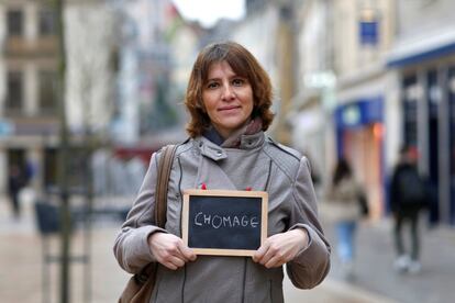 Nathalie Reperant, 45, an insurance company employee, holds a blackboard with the word "chomage" (unemployment), the most important election issue for her, as she poses for Reuters in Chartres, France February 1, 2017. She said: "Without a job and money, you're on your way to hell." REUTERS/Stephane Mahe SEARCH "ELECTION CHARTRES" FOR THIS STORY. SEARCH "THE WIDER IMAGE" FOR ALL STORIES