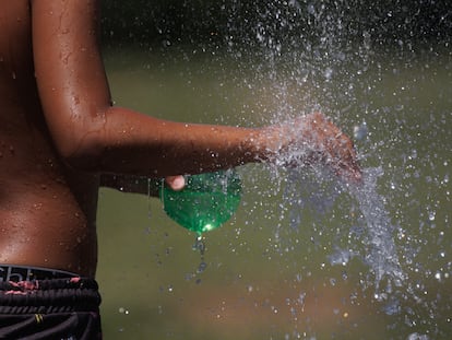 A young man cools off in Madrid on June 26, 2023.