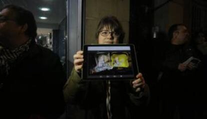 A local resident shows a picture of drug needles found in the area.