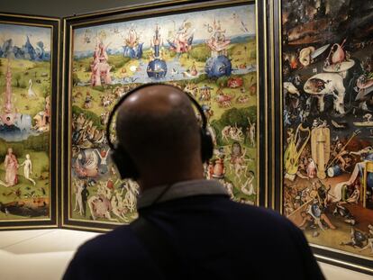 A visitor admires 'The Garden of Earthly Delights' by Hieronymus Bosch.