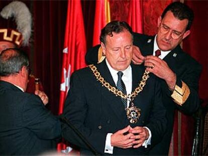 Un funcionario impone a Álvarez del Manzano el collar de alcalde de Madrid en julio de 1999.