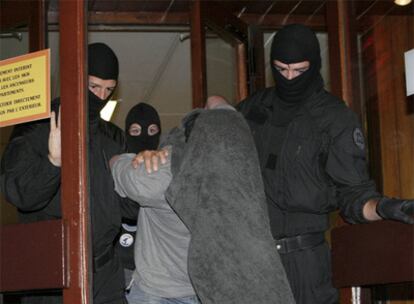 La policía francesa conduce a uno de los tres detenidos el miércoles en una estación de esquí de los Alpes franceses.