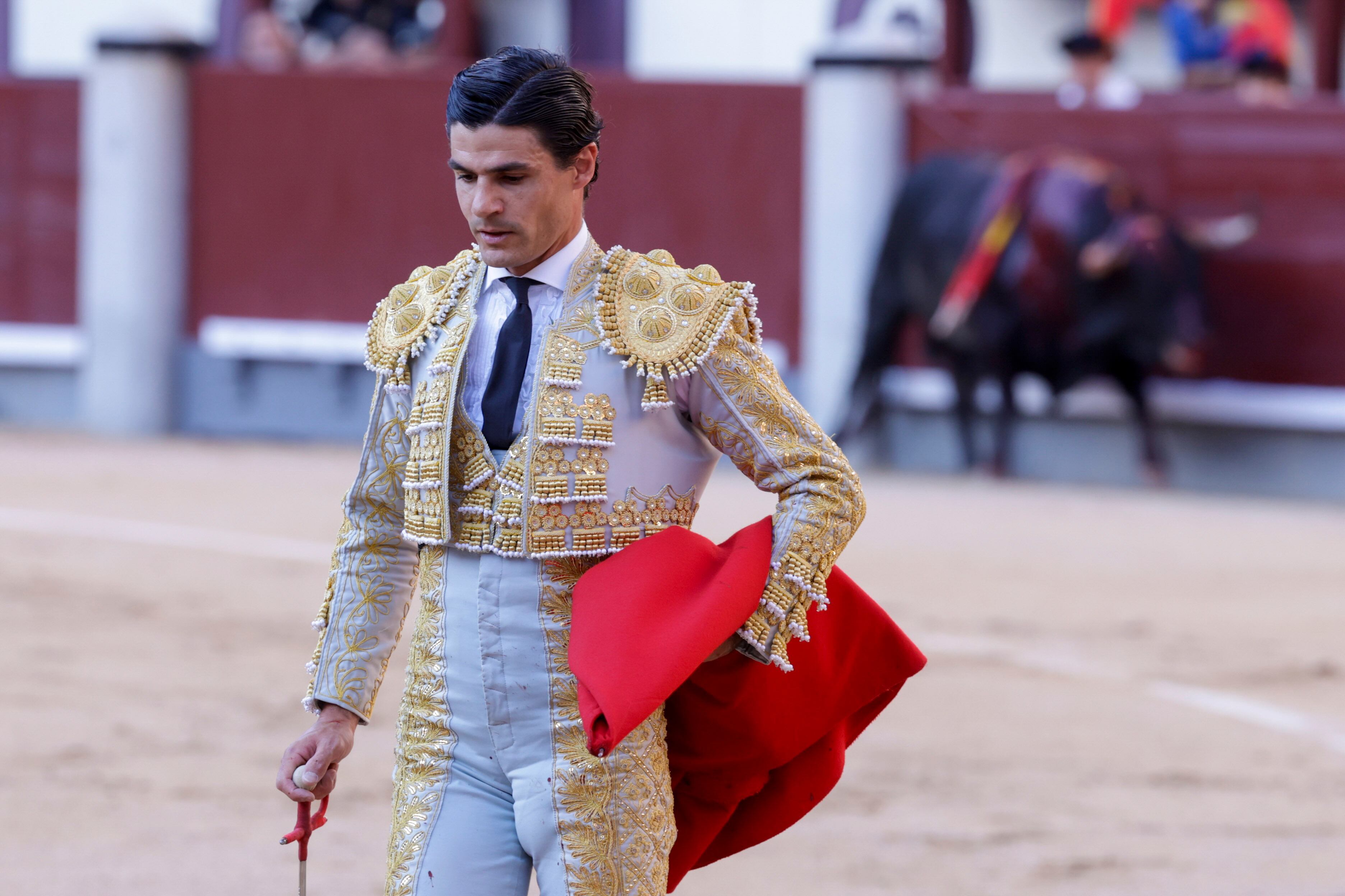 Pablo Aguado retreats to the alley after hearing the three warnings on his first bull.