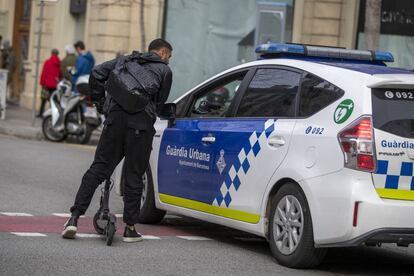 Local police issue a warning to a man on a scooter.