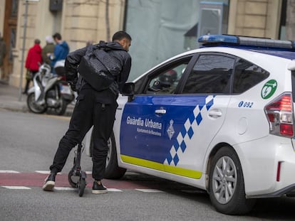 Local police issue a warning to a man on a scooter.