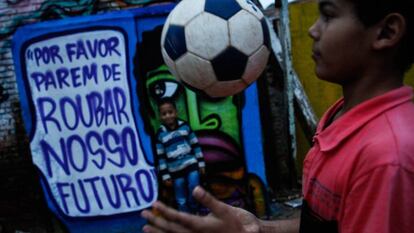 Dos ni&ntilde;os juegan en Brasil ante grafiti contra la corrupci&oacute;n.