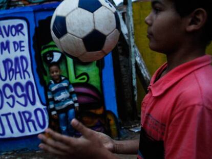 Dos ni&ntilde;os juegan en Brasil ante grafiti contra la corrupci&oacute;n.