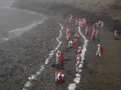 Trabajadores, durante la limpieza del derrame petrolero en Perú. 