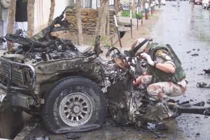 A soldier from the Spanish contingent examines the damage left by an attack in Herat in 2004. It did not cause any deaths.