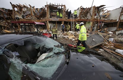 Un grupo de bomberos buscan entre los escombros algún superviviente en el bloque de apartamentos cercanos a la planta de fertilizantes que ha explotado en West, Texas (EE UU).