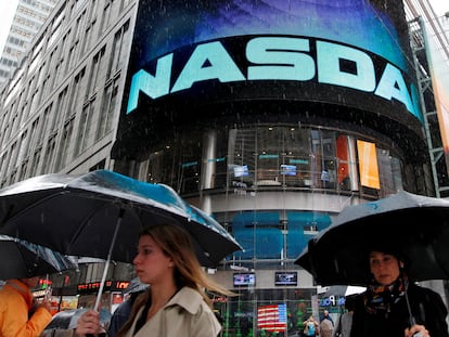 FILE PHOTO: Commuters pass by the NASDAQ Marketsite in New York, May 21, 2012. REUTERS/Brendan McDermid (UNITED STATES - Tags: BUSINESS)//File Photo