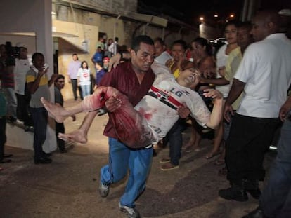 A prisoner from the Pedrinhas prison is carried to receive medical help after he was injured during a fight between rival gangs inside the jail on January 8.