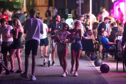 Tourists walk at the resort of Magaluf on the Balearic island of Mallorca.