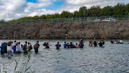 Migrant families cross the Rio Grande at the border between Eagle Pass, Texas, and Piedras Negras, Coahuila, Mexico, on October 12.