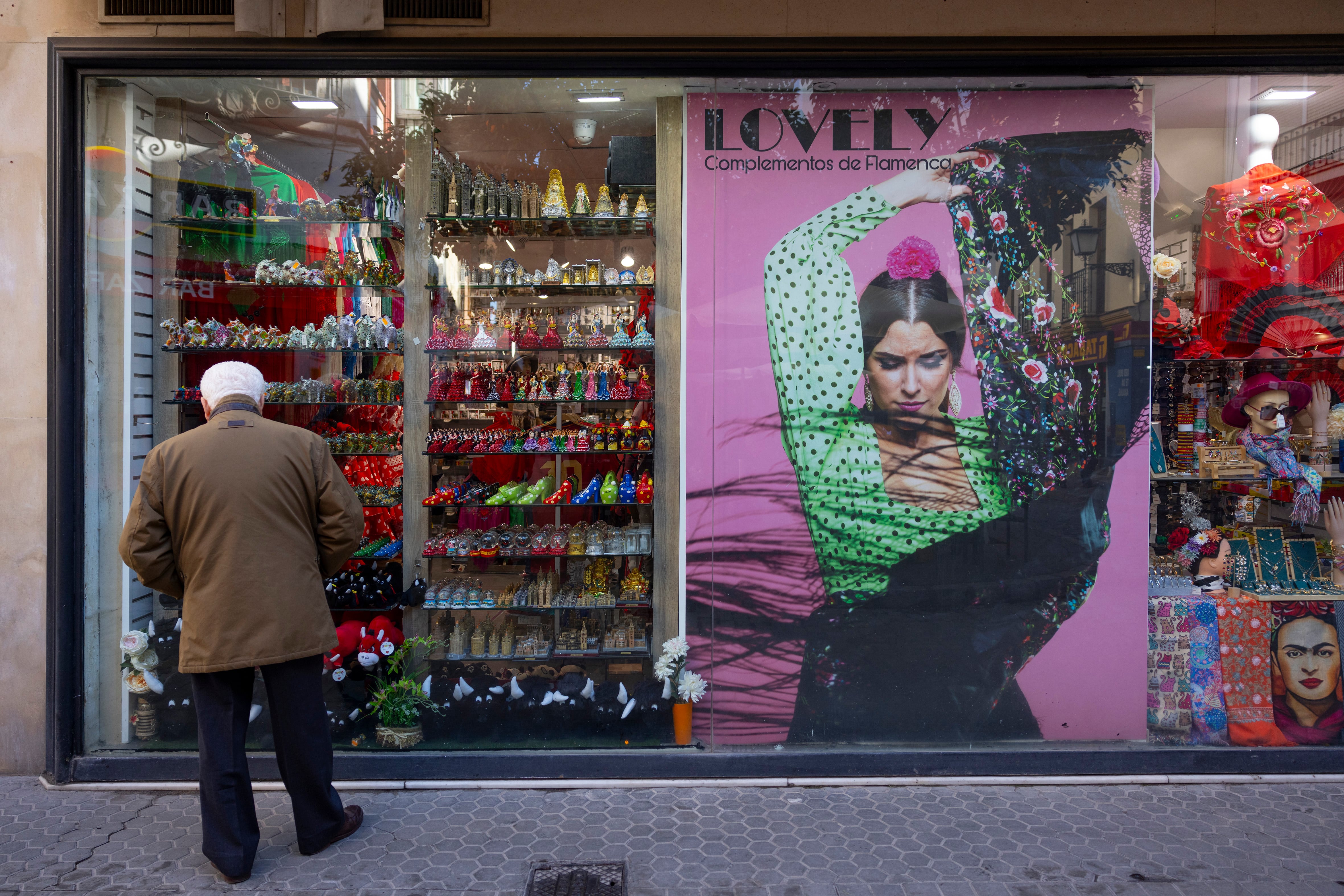 Un hombre mayor mira un escaparate en el centro de Sevilla. FOTO: PACO PUENTES (EL PAÍS).