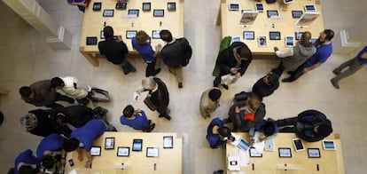 Clientes buscan en las mesas en las que se muestran el Apple IPAD 4G listo para Tablet PC en una de sus tiendas en París, 16 de marzo 2012.