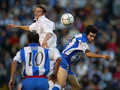 Rubén y Valerón saltan por un balón en presencia de Fran, de espaldas.