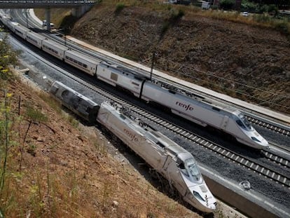 An Alvia train passes the wreckage of the Santiago crash.