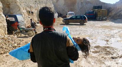 Un hombre con el cadáver de un niño tras el presunto ataque químico.