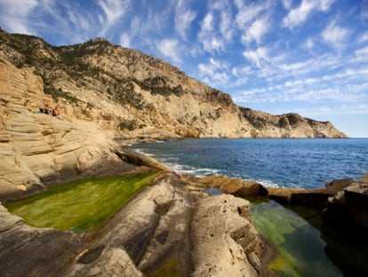 Estanques de agua verdosa formados en la roca en Sa Pedrera, al oeste de Ibiza