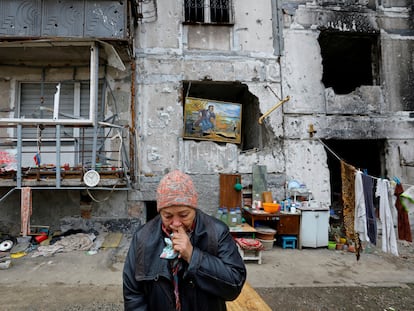 Local resident Galina Shevtsova reacts outside the apartment building where she lives in the basement with her husband Pavel after their flat was destroyed in March 2022 in the course of Russia-Ukraine conflict, in Mariupol, Russian-controlled Ukraine, November 16, 2022. REUTERS/Alexander Ermochenko     TPX IMAGES OF THE DAY
