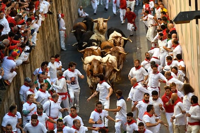 Revelers run with six fighting bulls from the Cebada Gago ranch during the second day of the Running of the bulls at the San Fermín fiestas in Pamplona on Monday, July 8, 2024. 