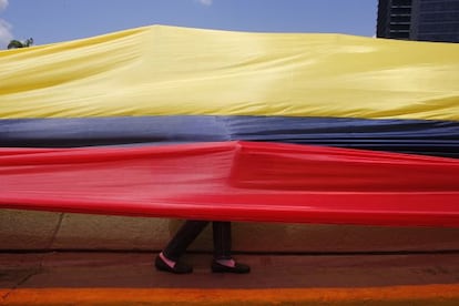 Um m&eacute;dico caminha sob a bandeira em um protesto que pedia material hospitalar. 